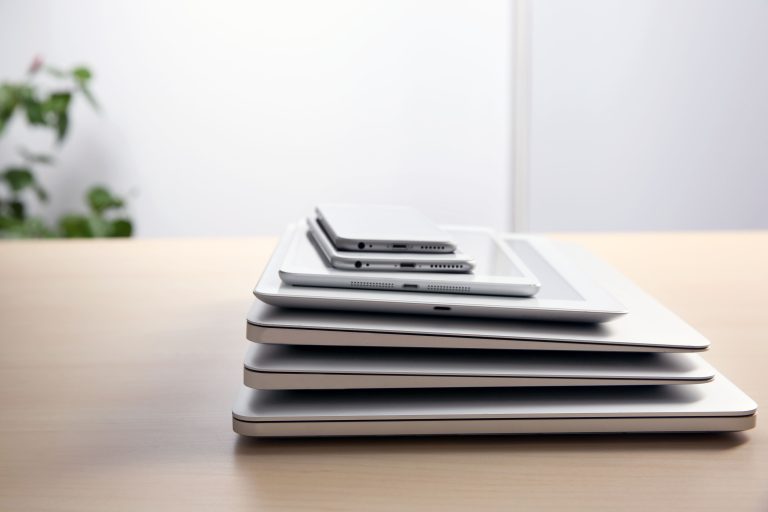 stack of electronic devices on wooden table
